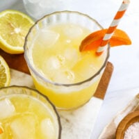 adrenal cocktail with orange slice and straw.