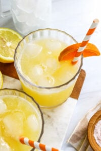 adrenal cocktail with orange slice and straw.