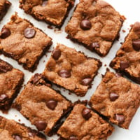 almond butter blondies sliced on white surface.