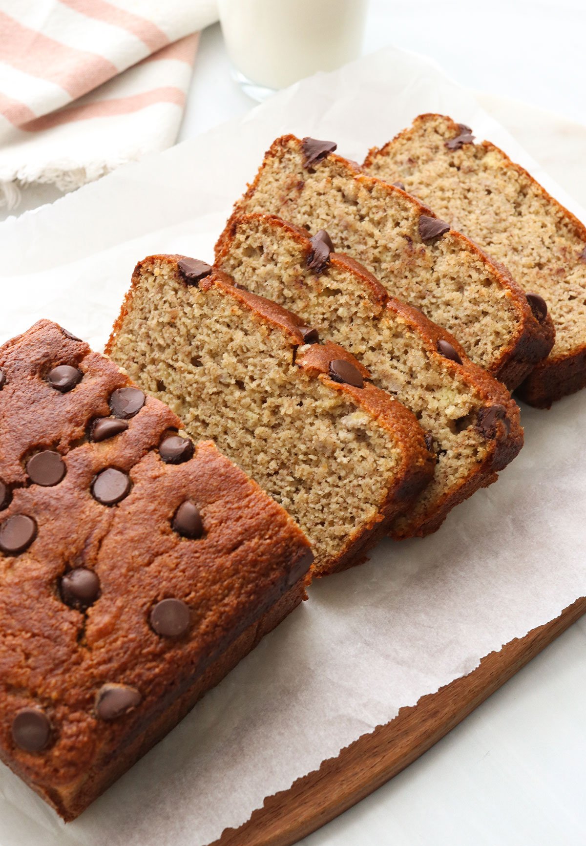 almond flour banana bread sliced on white cutting board.