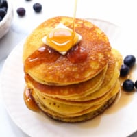 almond flour pancakes topped with butter and maple syrup.