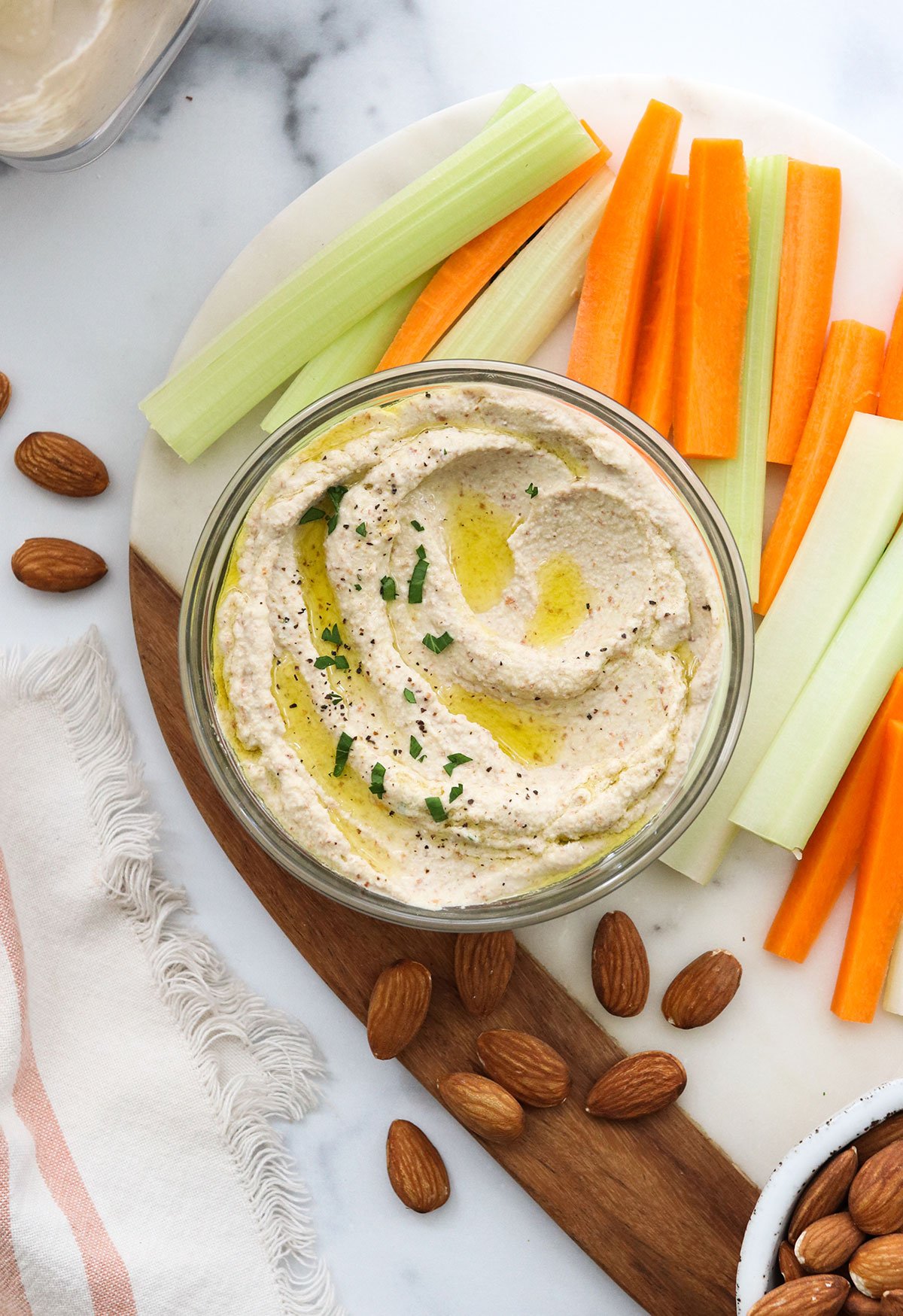 almond pulp hummus served with carrots and celery sticks.