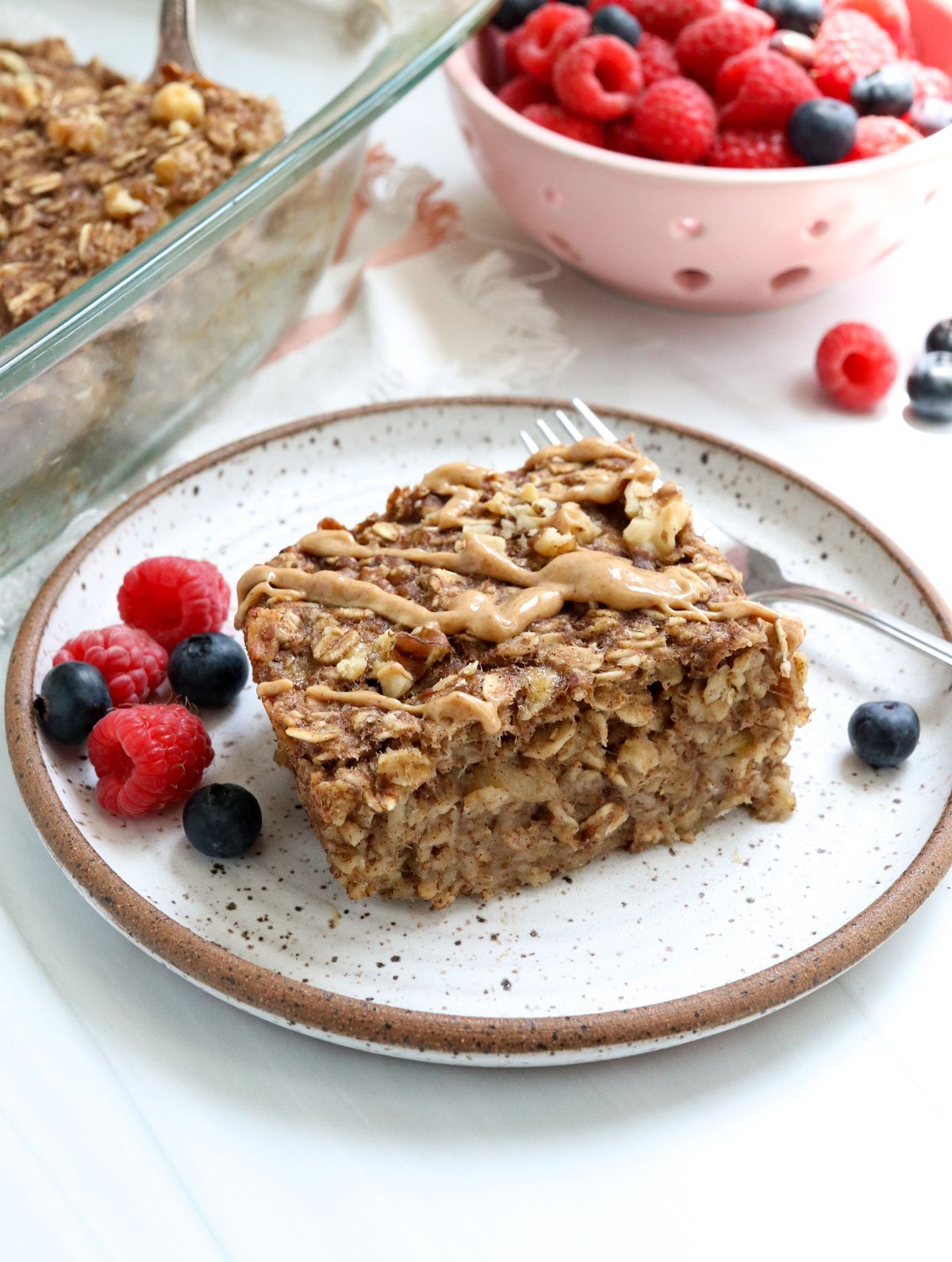 baked banana oatmeal sliced topped with peanut butter.