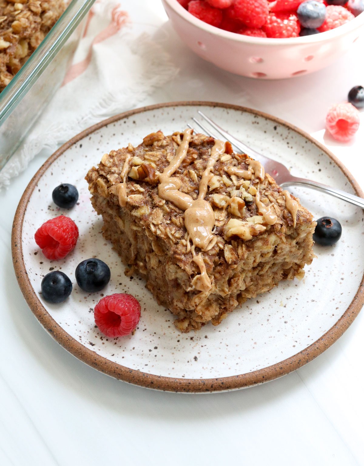 banana baked oatmeal served with berries.