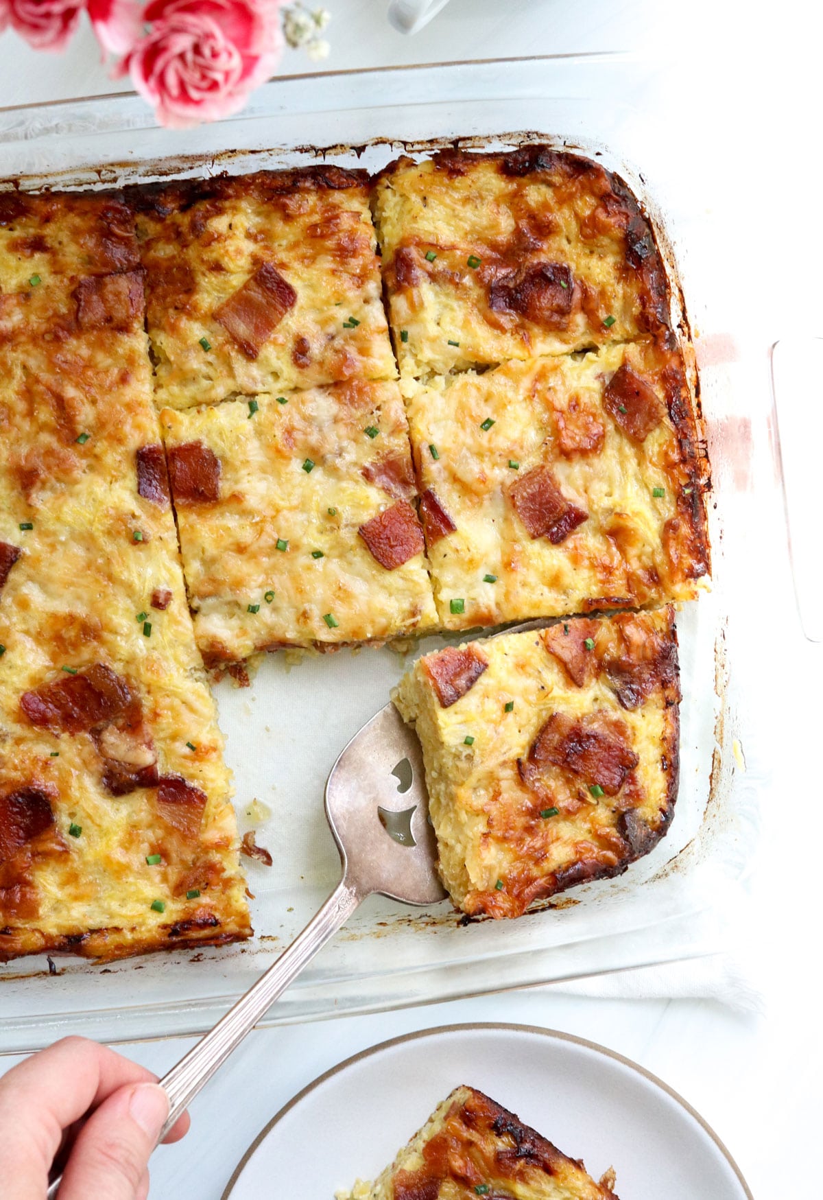 breakfast casserole sliced and served with spatula.