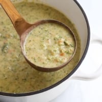 broccoli cheddar soup lifted up on ladle.