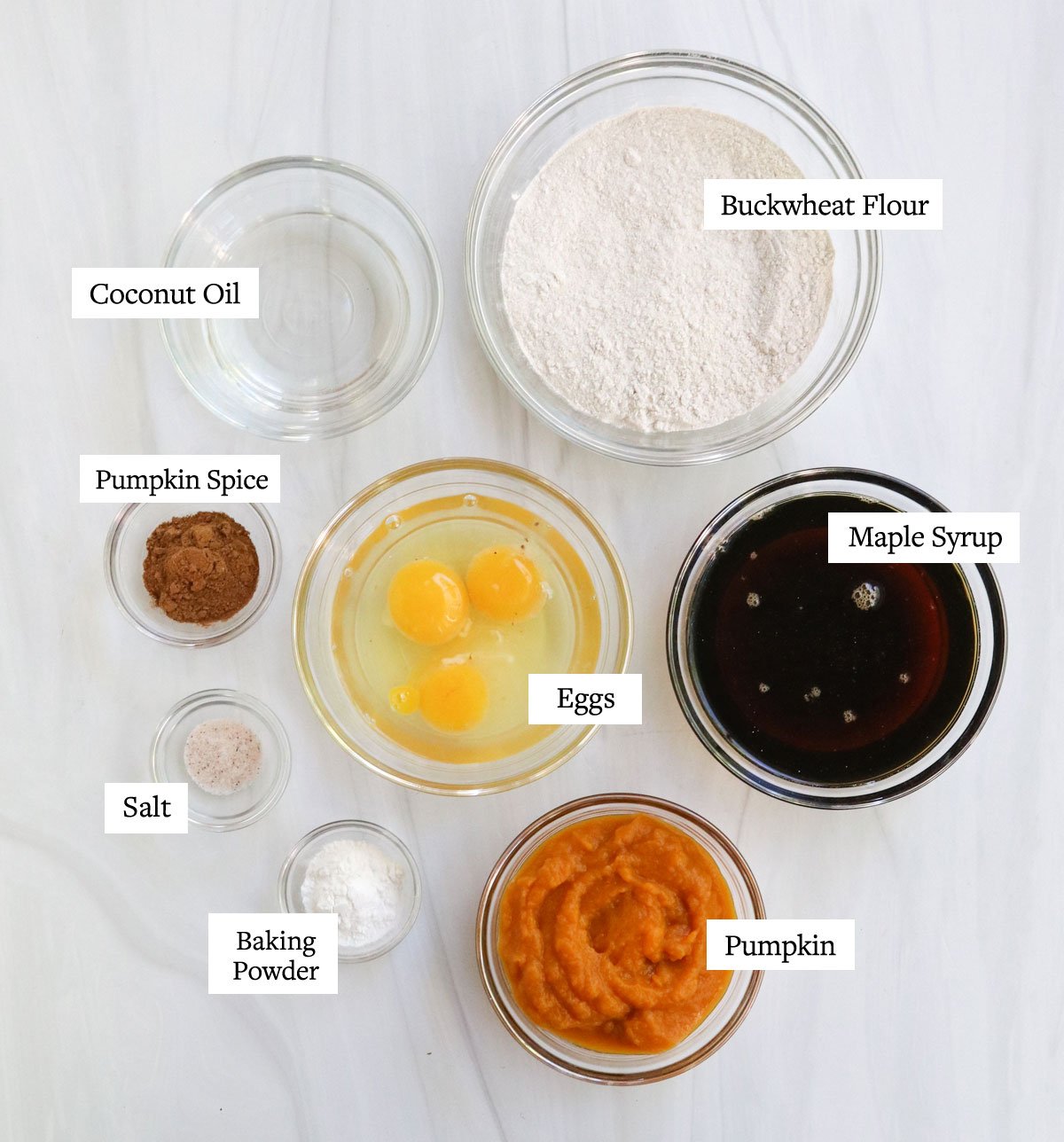 buckwheat pumpkin bread ingredients labeled in glass bowls.