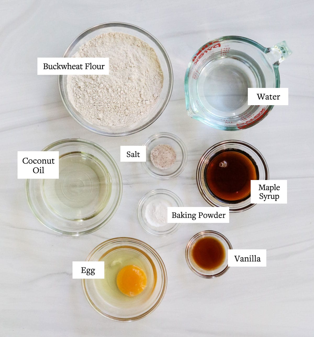 buckwheat waffle ingredients labeled in glass bowls.