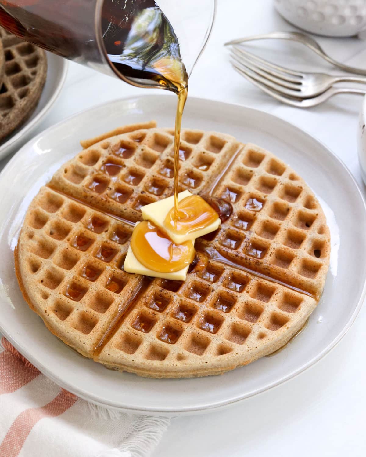 buckwheat waffle with butter and syrup on top.