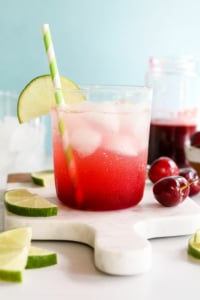 cherry limeade garnished with lime slices.