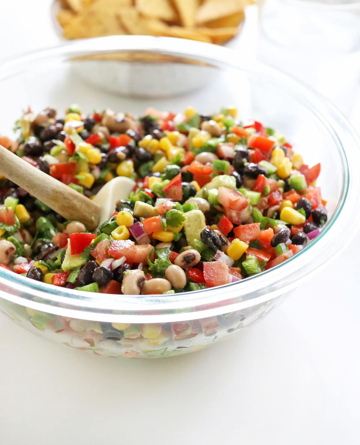 bowl of texas caviar with chips behind it