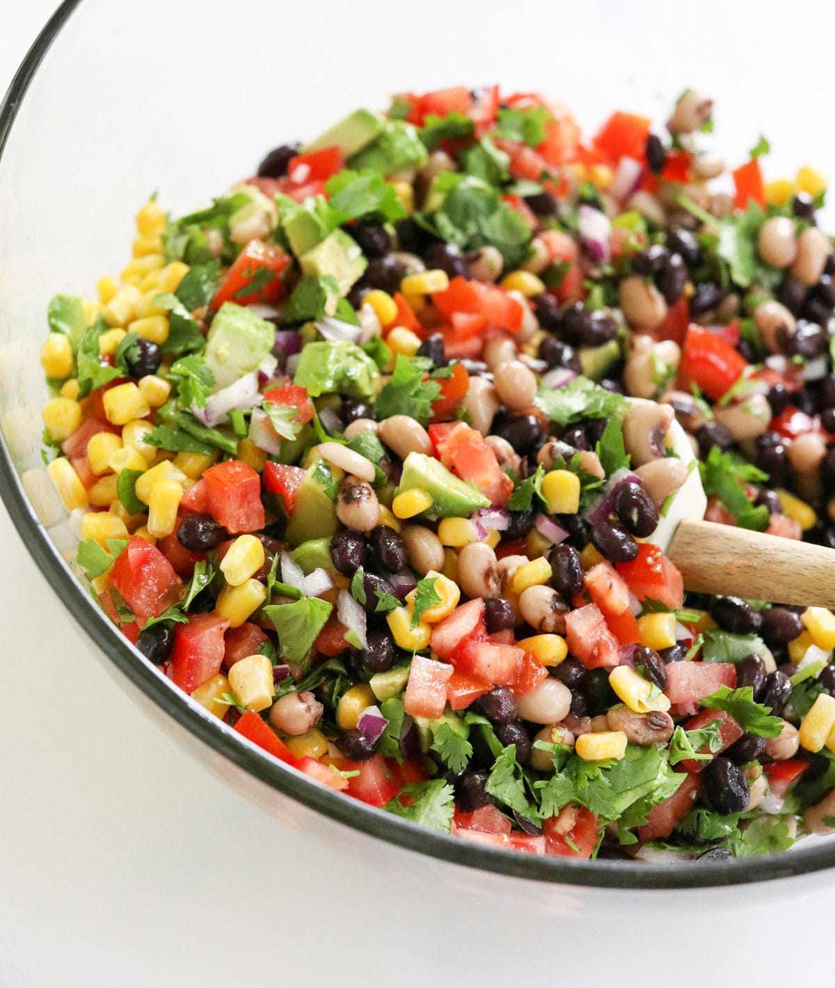 chopped veggies and beans in glass bowl