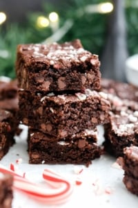 oat flour peppermint brownies stacked in front of garland