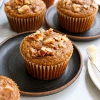 banana muffins with walnuts on top.