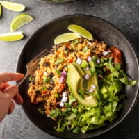quinoa vegan burrito burrito bowl with lime overhead view