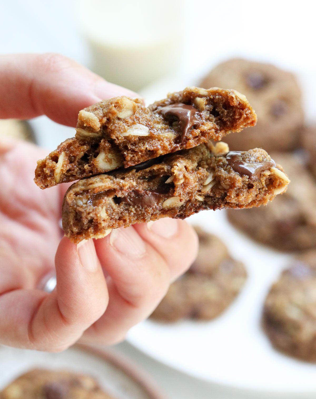 hand holding a lactation cookie split in half.