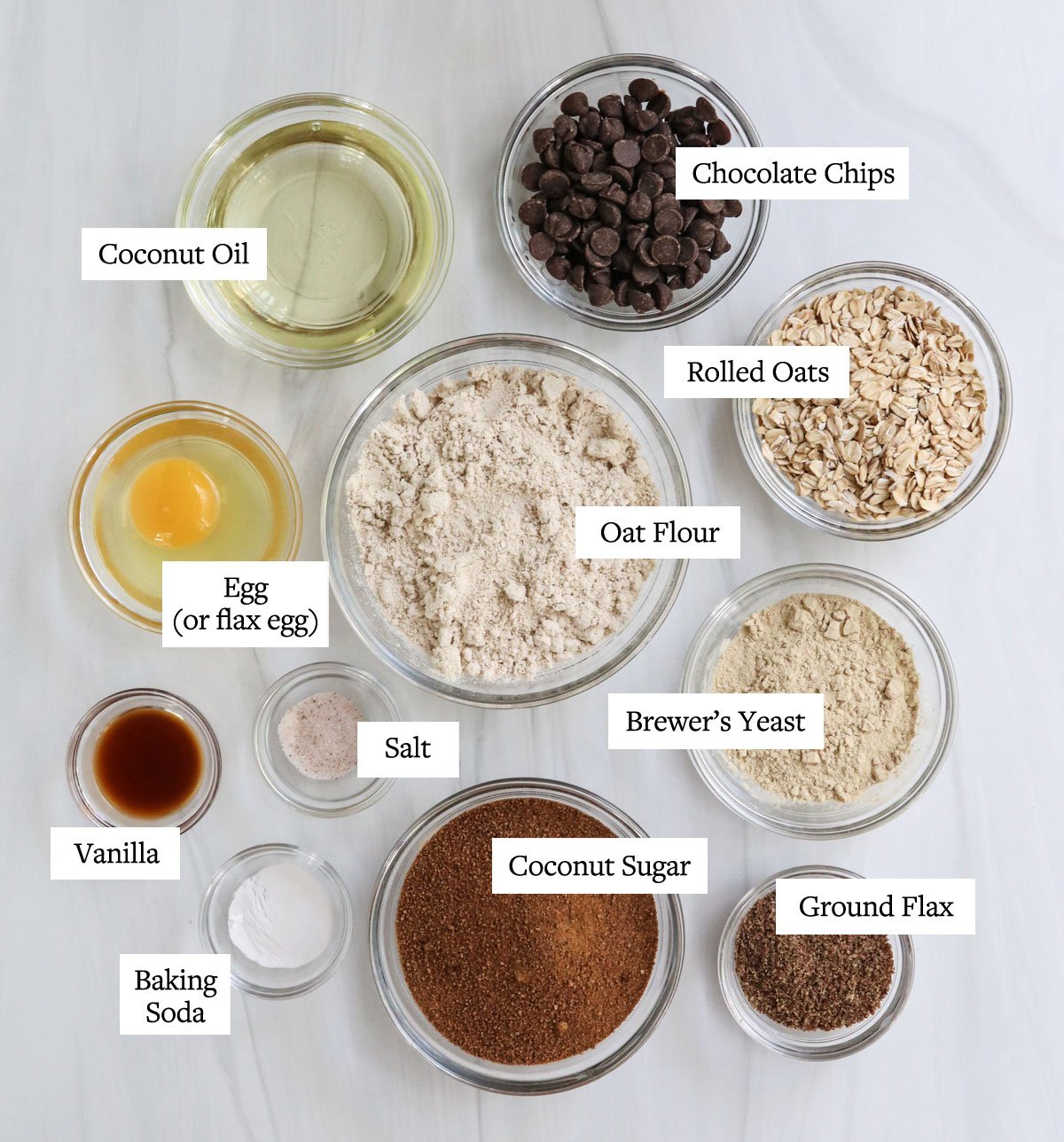 lactation cookie ingredients labeled in glass bowls.