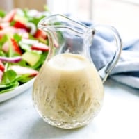 lemon poppy seed dressing in glass pitcher