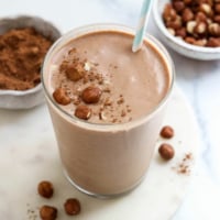 chocolate hazelnut smoothie in glass with straw