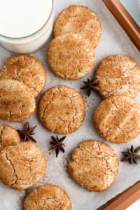 almond flour snickerdoodle cookies on baking sheet with milk