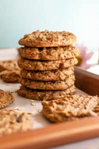 peanut butter oatmeal cookies stacked on pan.