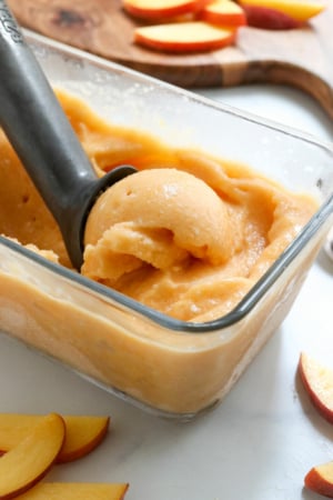 peach ice cream scooped in pan