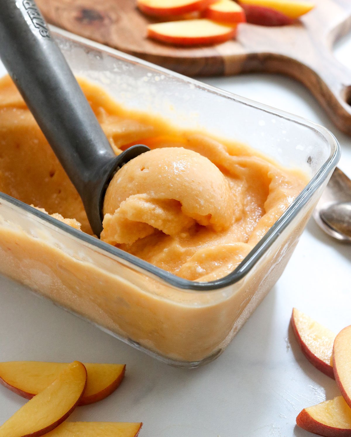 peach ice cream scooped in pan