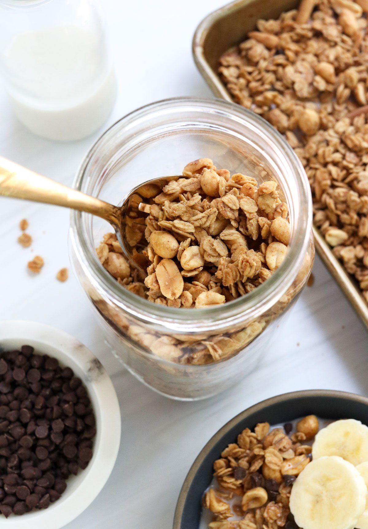 peanut butter granola in a large glass mason jar.