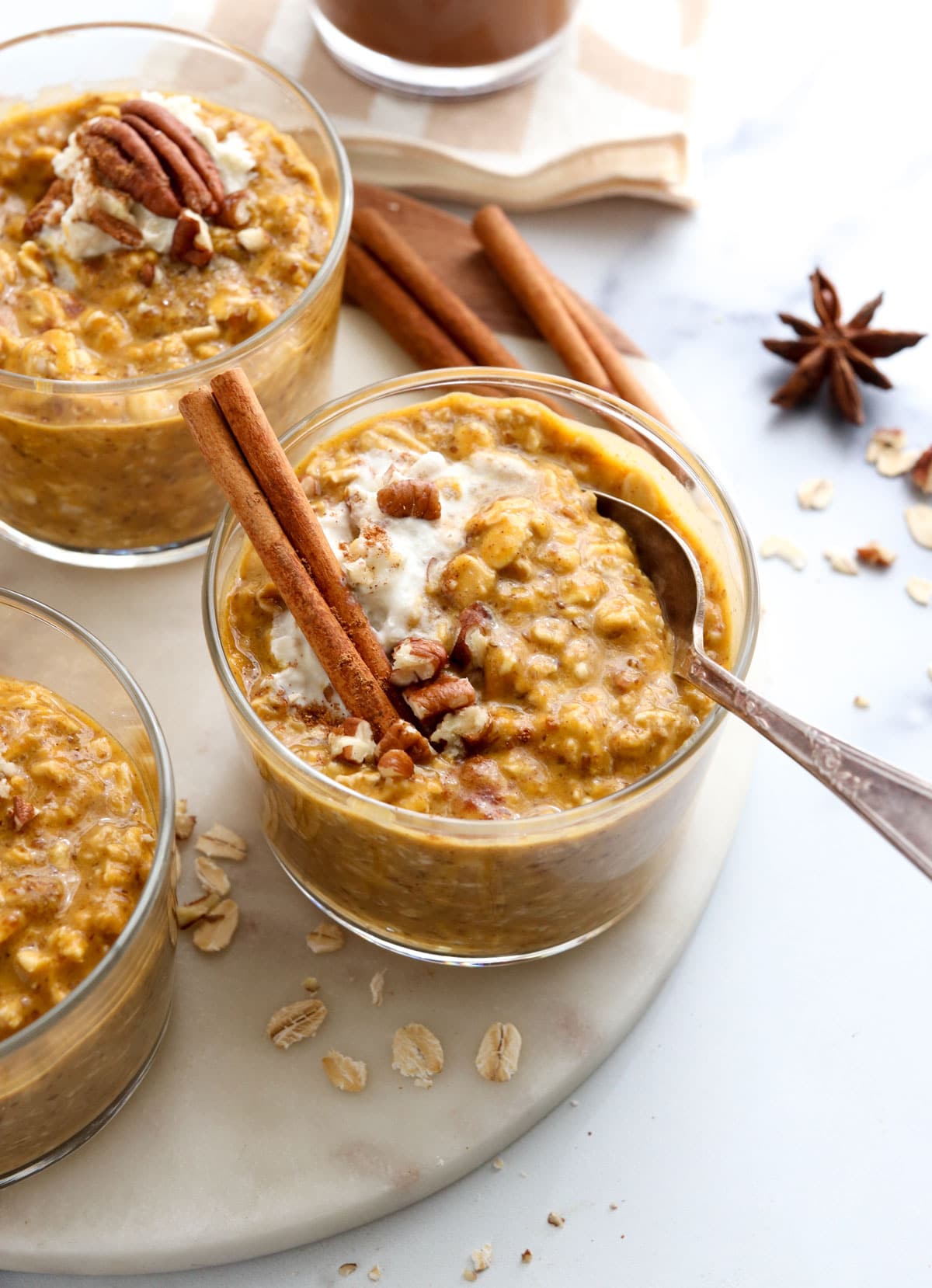 3 jars of pumpkin overnight oats with spoon