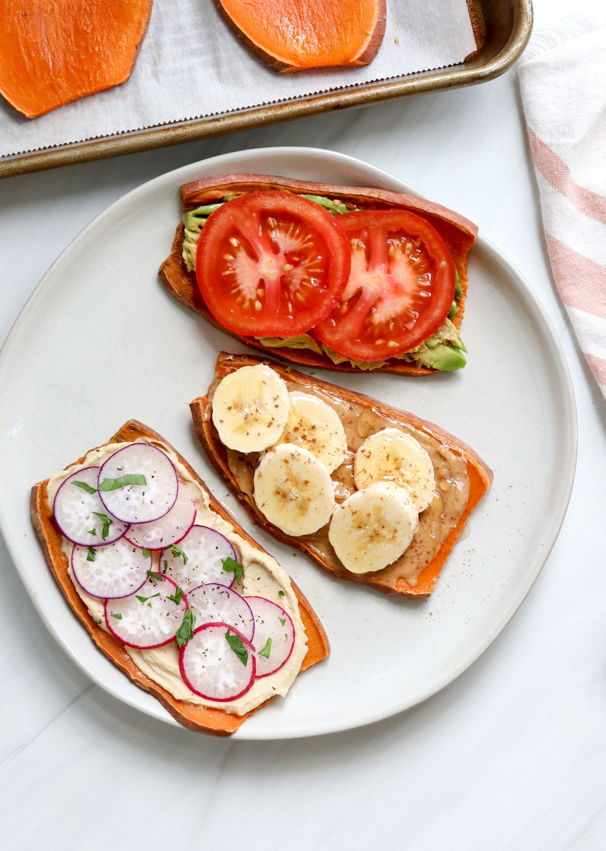 sweet potato toast topped with tomatoes, banana, and radishes.