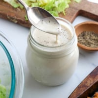 vegan caesar dressing dripping off a spoon