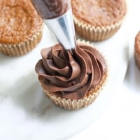 vegan ganache piped onto cupcake