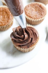 vegan ganache piped onto cupcake