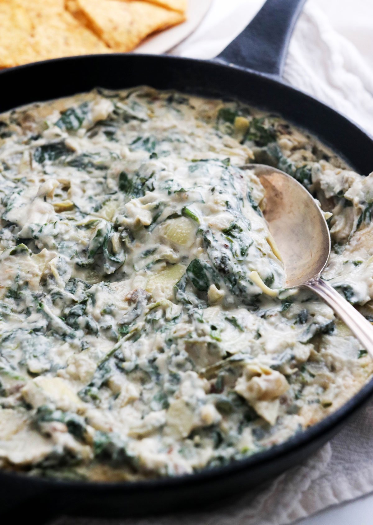 vegan spinach artichoke dip in cast iron skillet