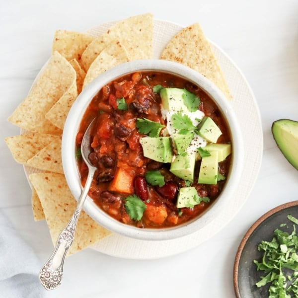 veggie chili in bowl with avocado on top